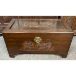 A 20th century camphor chest, two panel carved wit