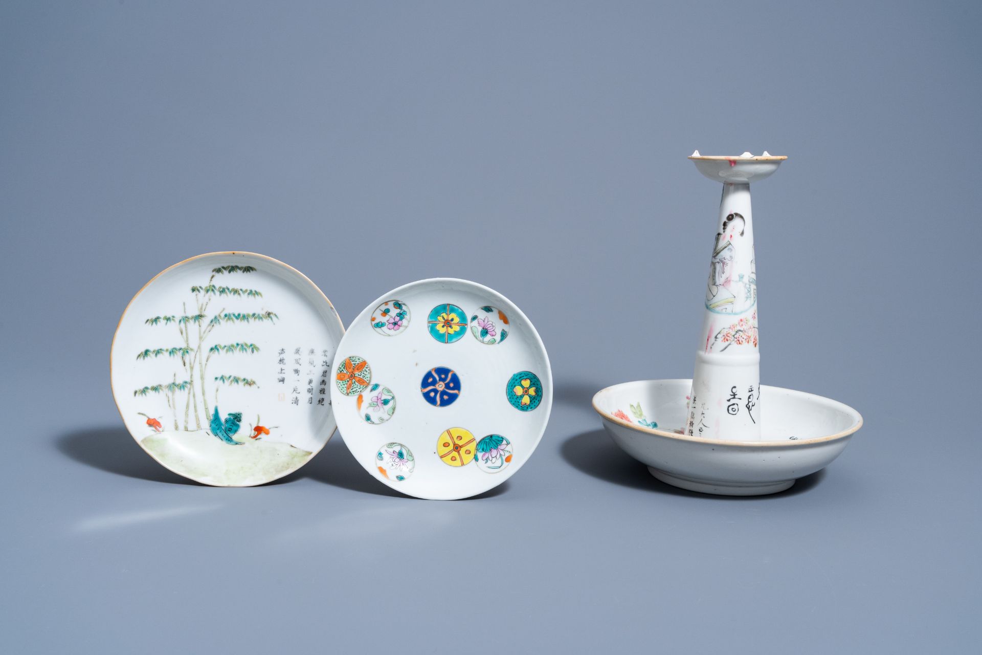 A Chinese qianjiang cai candle holder and two famille rose and verte saucer dishes, 19th/20th C.