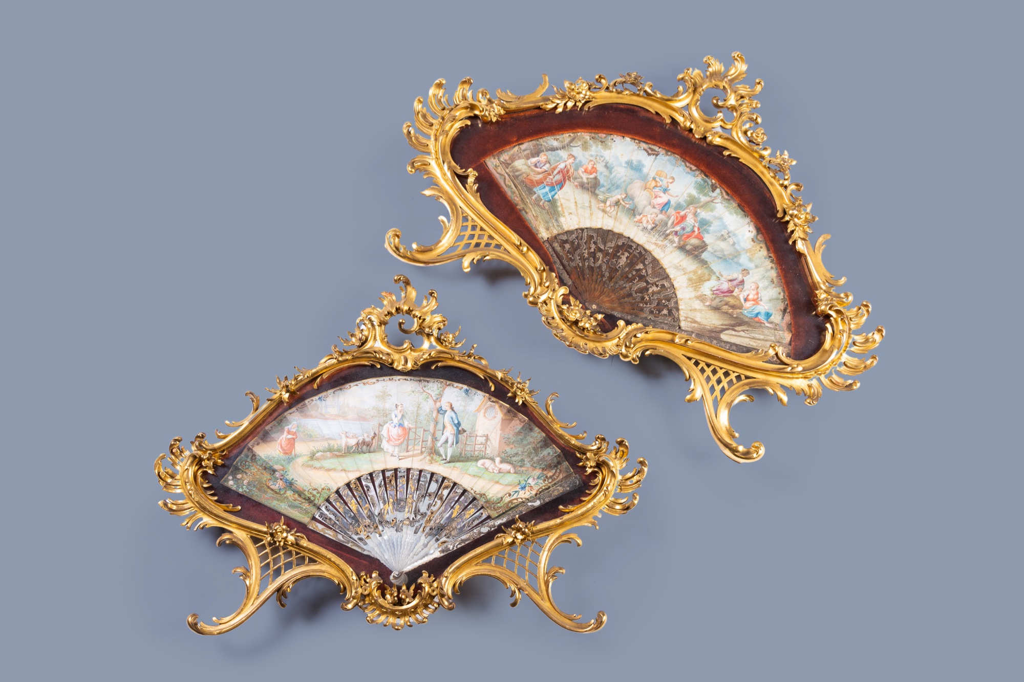 Two finely finished and painted mother-of-pearl, tortoiseshell and silk fans with a gallant scene an