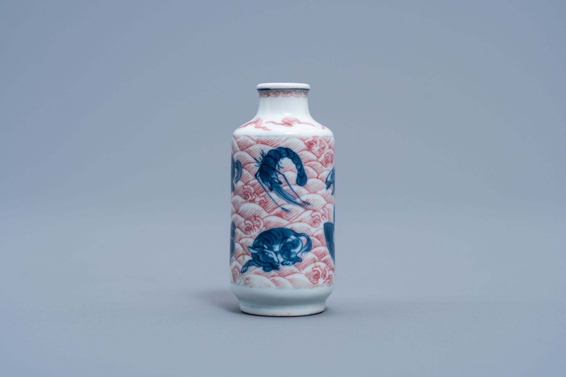 A Chinese blue, white and copper red 'animals' snuff bottle, Yongzheng mark, 20th C. - Image 3 of 6