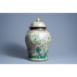 A Chinese Canton famille rose celadon ground vase and cover with birds, parrots and butterflies amon