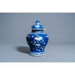 A Chinese blue and white prunus on cracked ice ground vase and cover, Kangxi mark, 19th C.