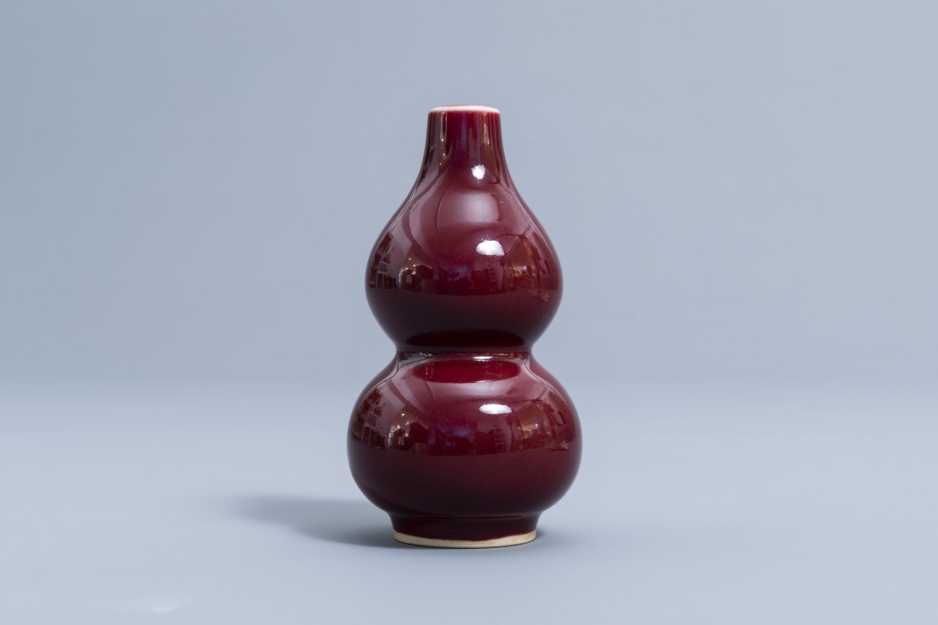 A pair of Chinese red glazed parrots and a monochrome red double gourd vase, 20th C. - Image 8 of 13