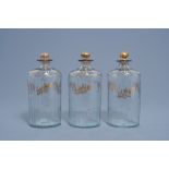 Three French cut glass flasks and covers with gilt floral design, 18th C.