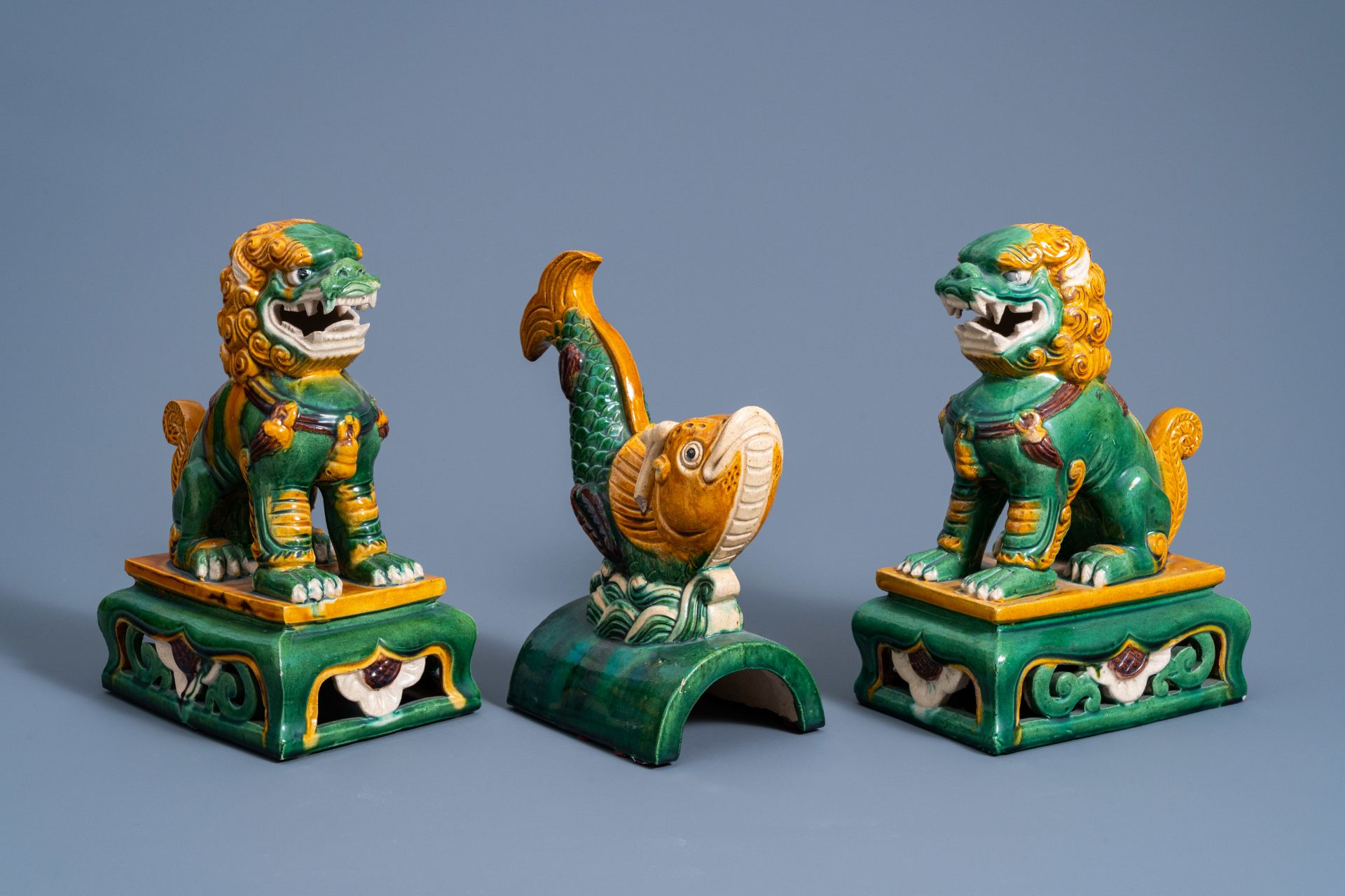 A Chinese sancai fish-form roof tile and two temple lions, 20th C.