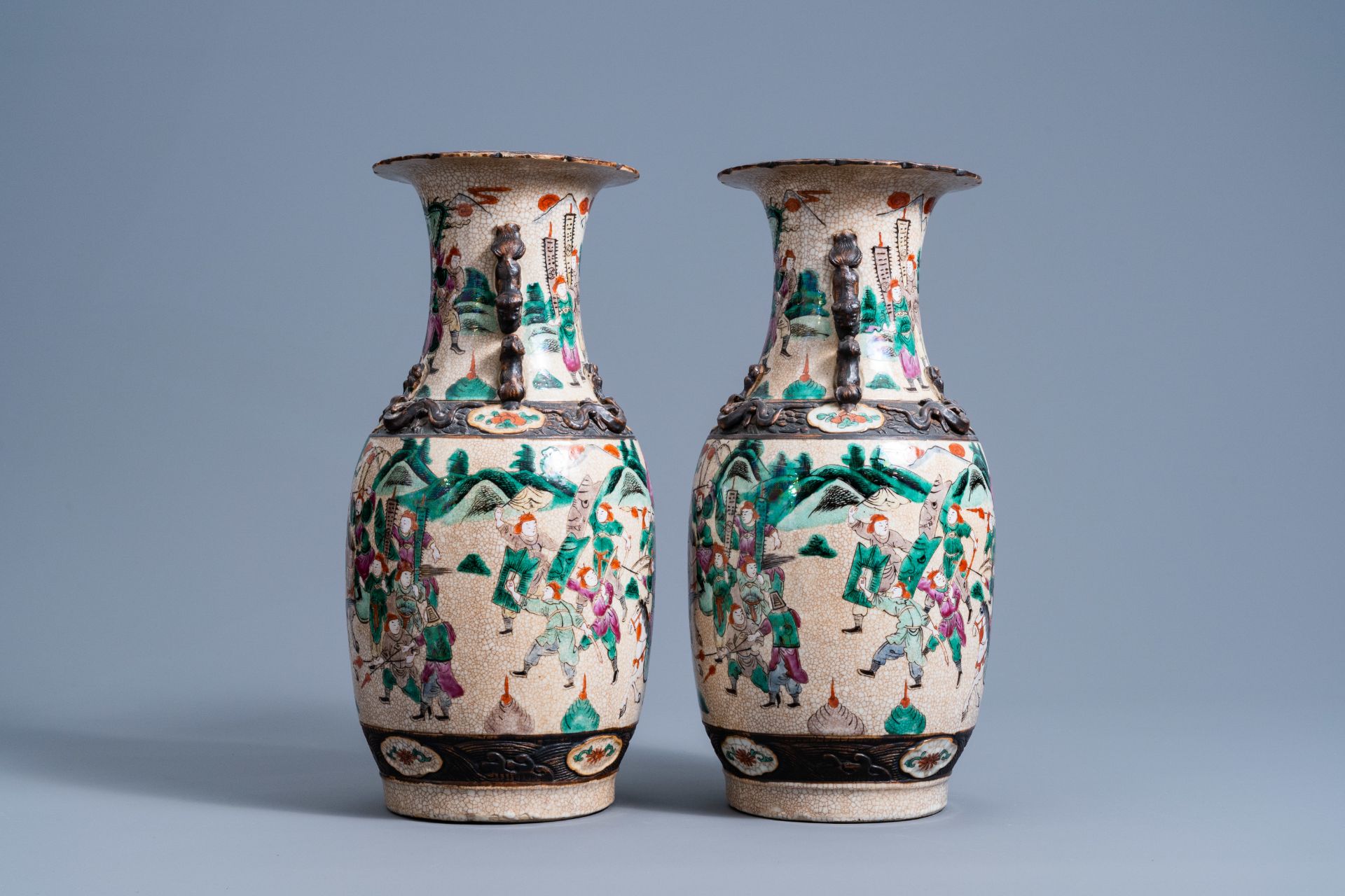 A pair of Chinese Nanking crackle glazed famille rose vases with warrior scenes, 19th C. - Image 4 of 6
