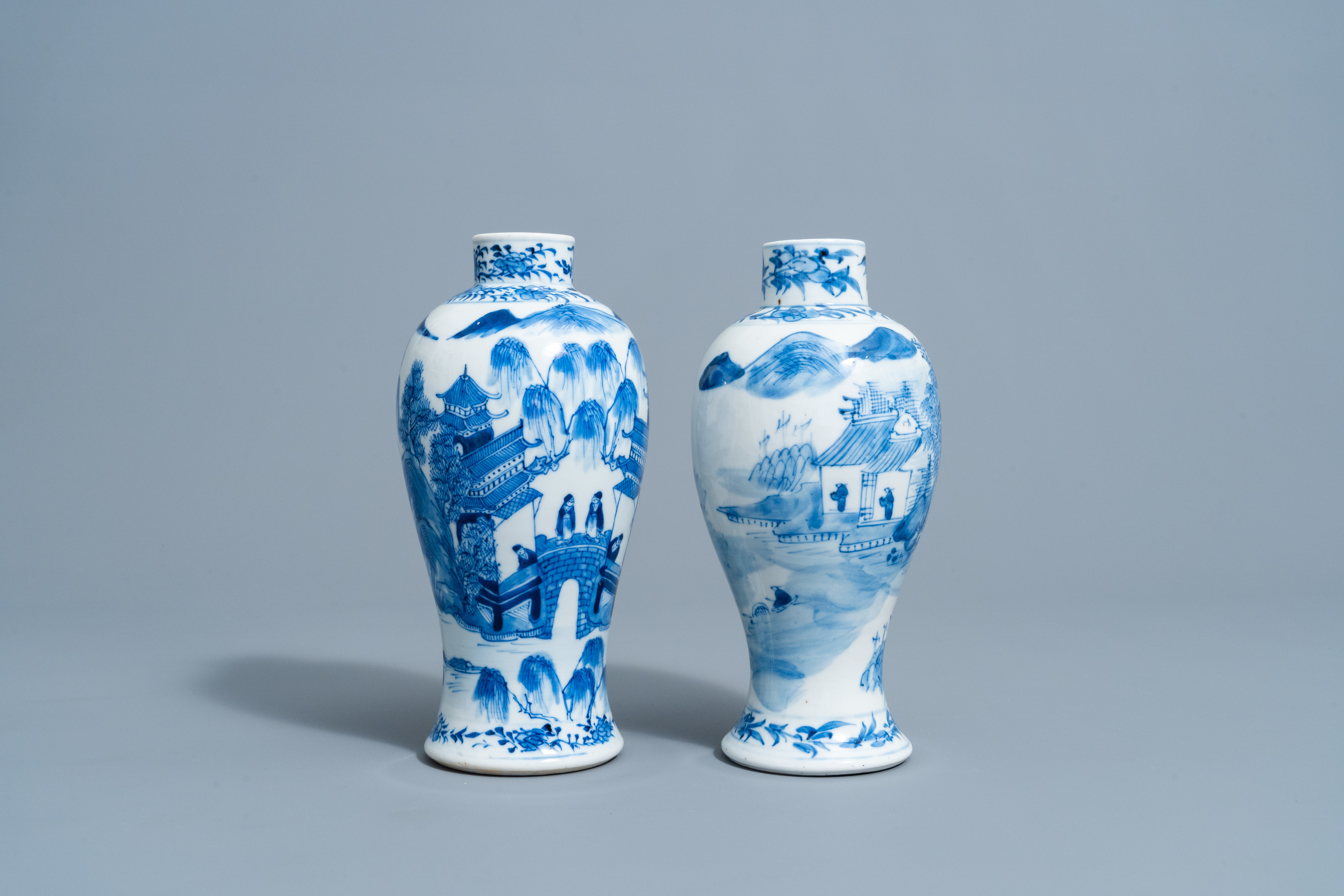 Two Chinese blue and white baluster shaped vases with an animated mountain landscape all around, Kan