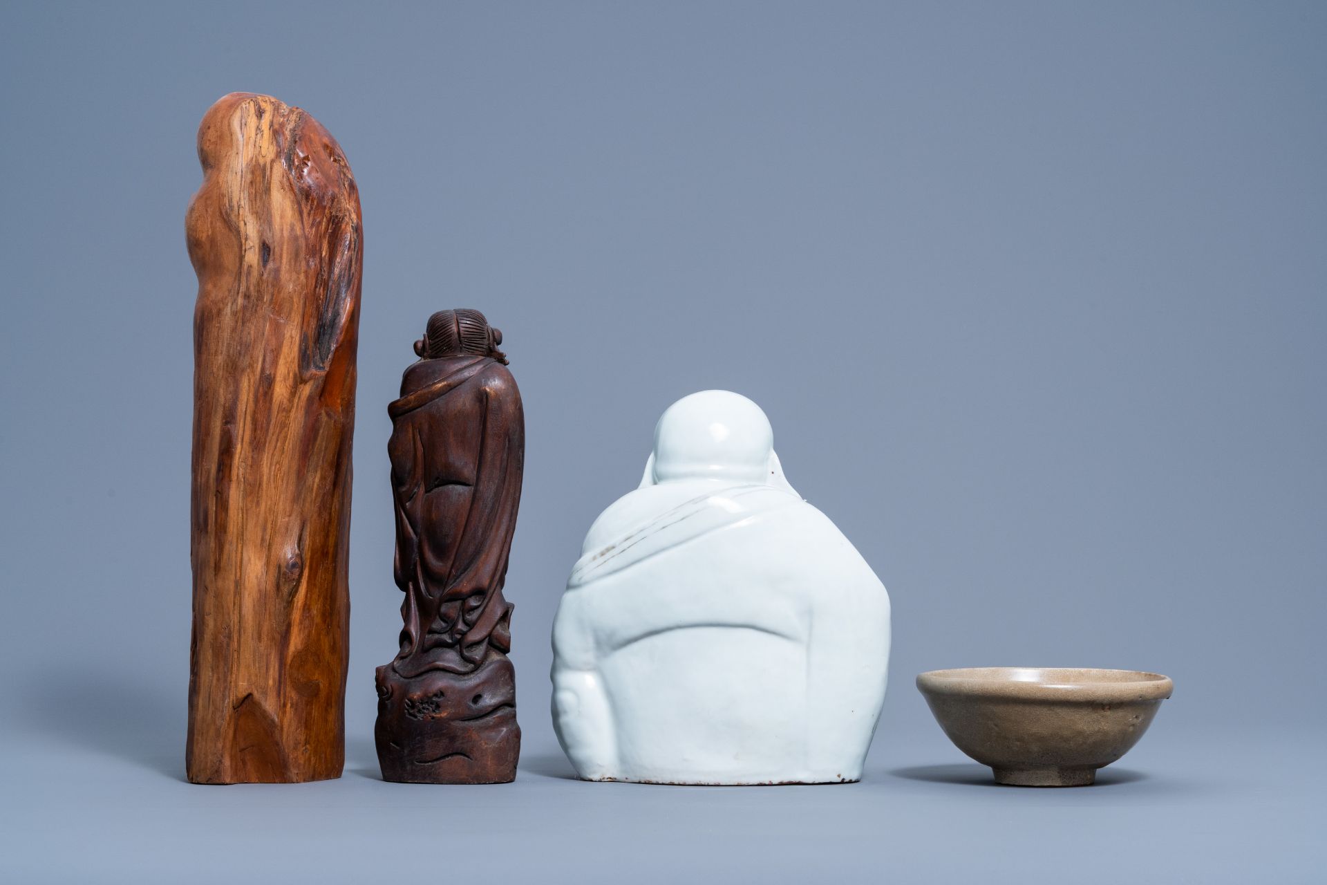 A Chinese white, iron red and gilt porcelain figure of Buddha, two carved wood figures and a celadon - Image 3 of 7