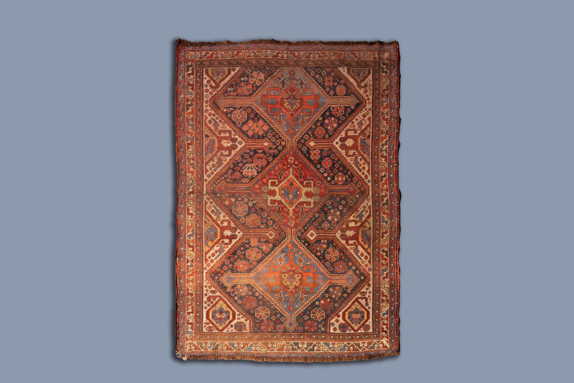 A Caucasian rug with geometric patterns and floral design, wool on cotton, 19th C.