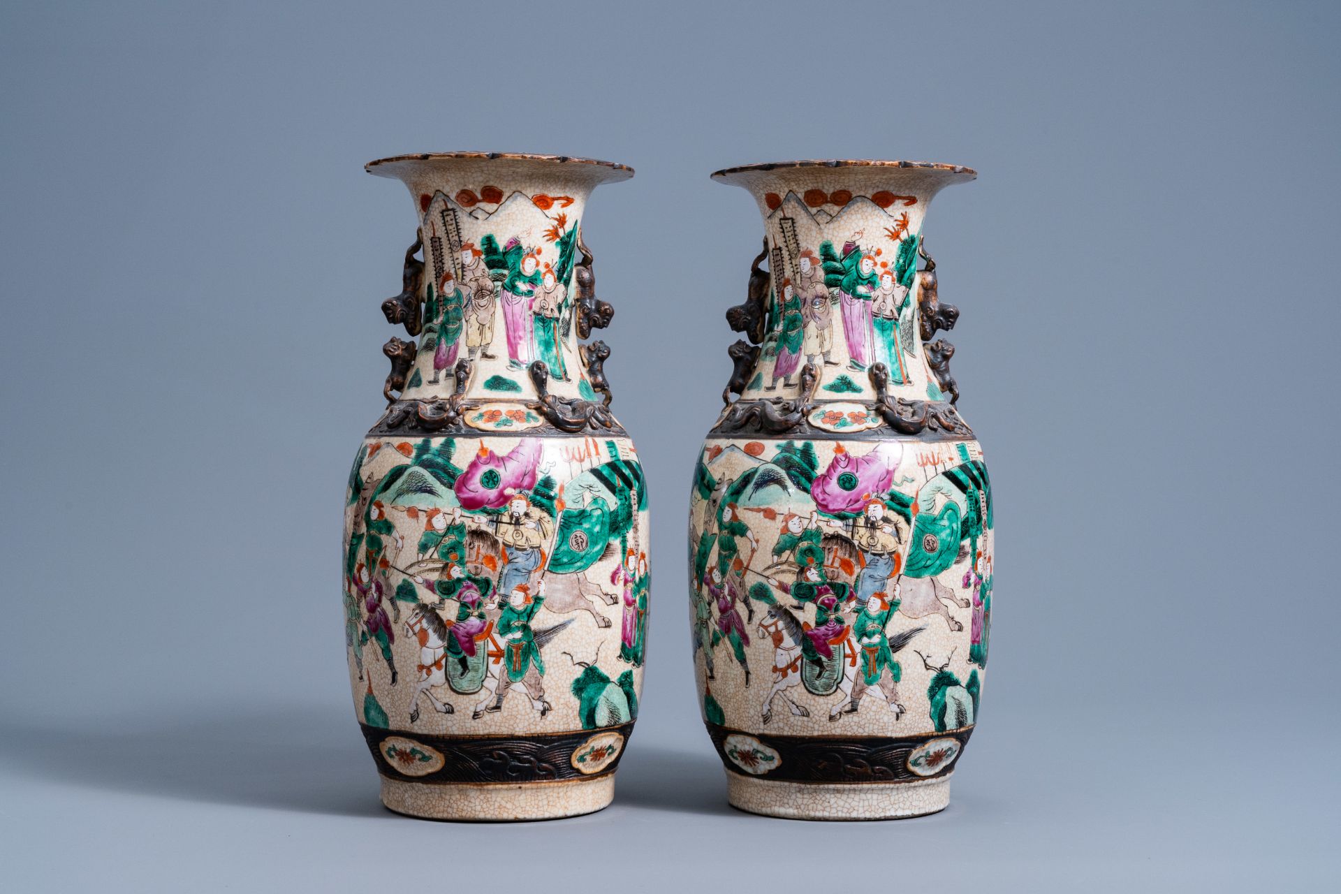 A pair of Chinese Nanking crackle glazed famille rose vases with warrior scenes, 19th C.