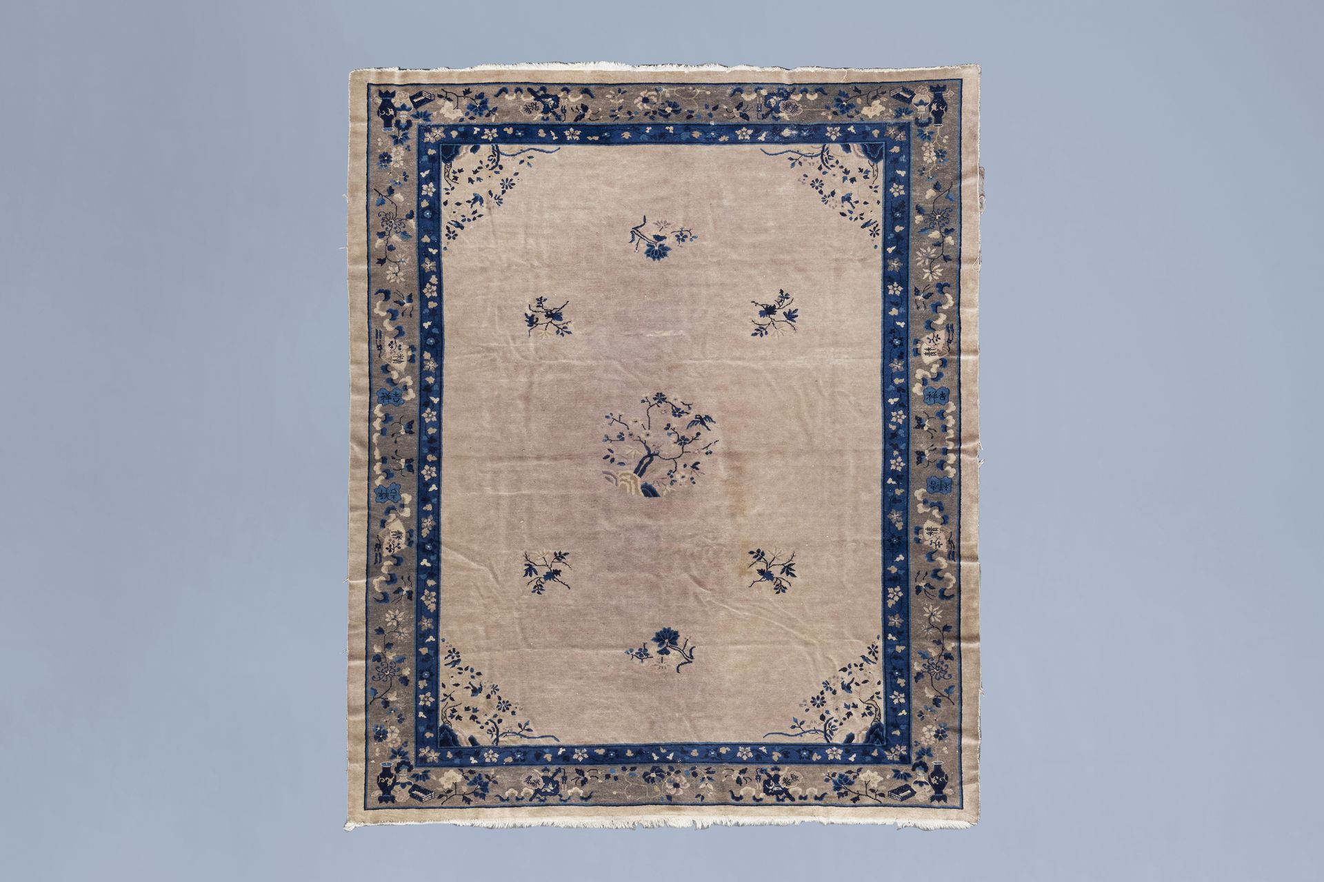 A Chinese 'Peking' rug with floral design, wool on cotton, first half of the 20th C.