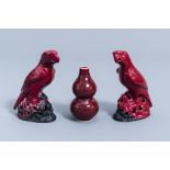 A pair of Chinese red glazed parrots and a monochrome red double gourd vase, 20th C.