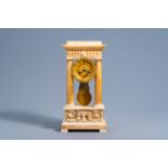 A French bronze and alabaster column mantel clock with floral design, 19th C.