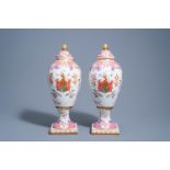 A pair of Samson porcelain Chinese famille rose style armorial vases and covers, Paris, 19th C.