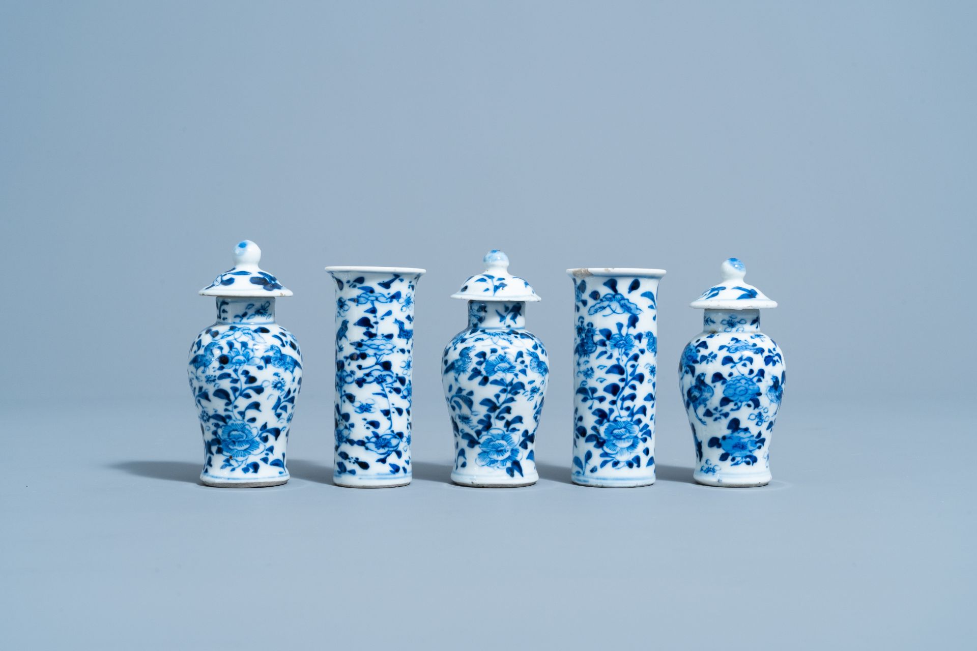 A Chinese blue and white five-piece garniture with floral design, 19th C.