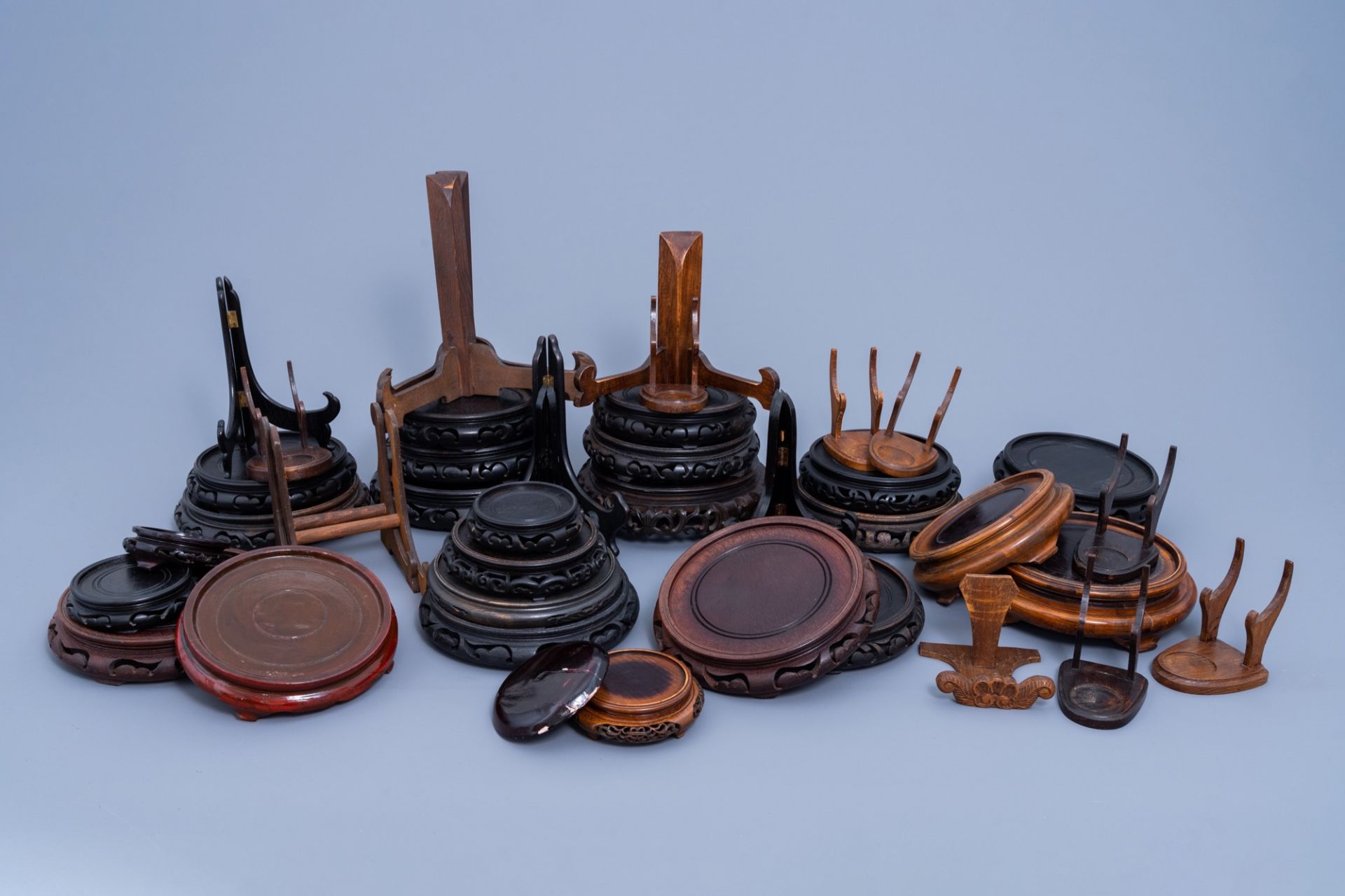 A collection of Chinese carved wood stands and plate holders, 20th C.