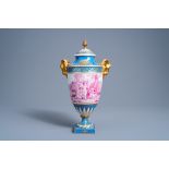A French gold layered 'bleu celeste' ground vase and cover with putti in a landscape and ram's heads