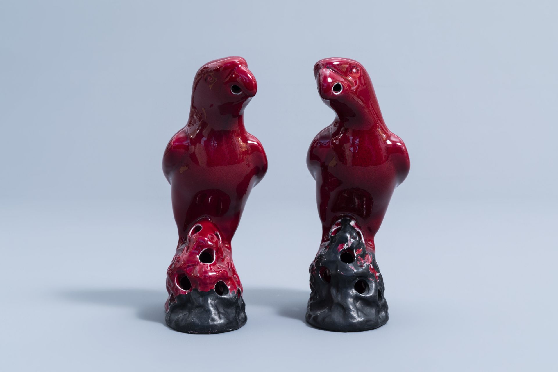 A pair of Chinese red glazed parrots and a monochrome red double gourd vase, 20th C. - Image 2 of 13