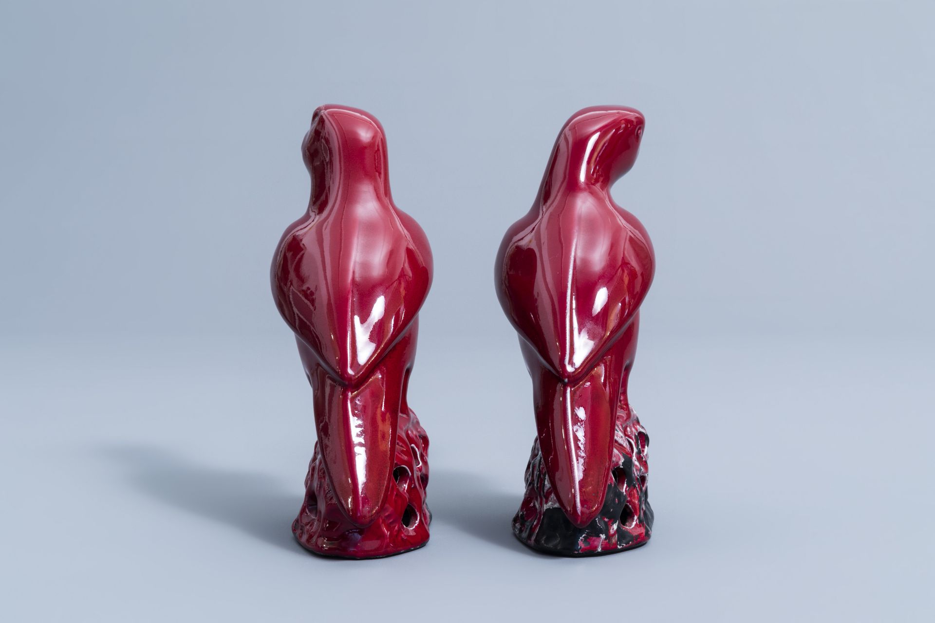 A pair of Chinese red glazed parrots and a monochrome red double gourd vase, 20th C. - Image 3 of 13