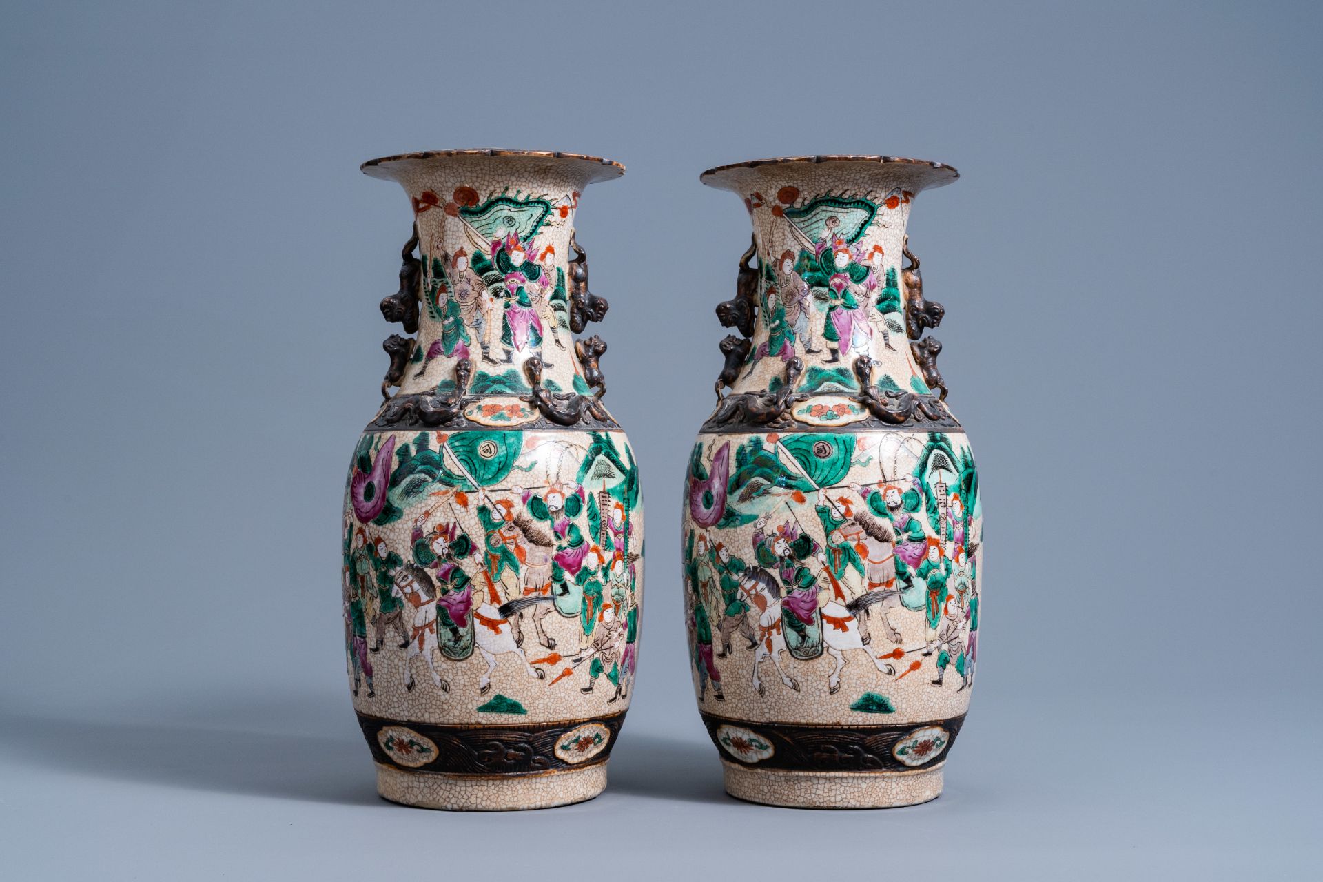 A pair of Chinese Nanking crackle glazed famille rose vases with warrior scenes, 19th C. - Image 3 of 6