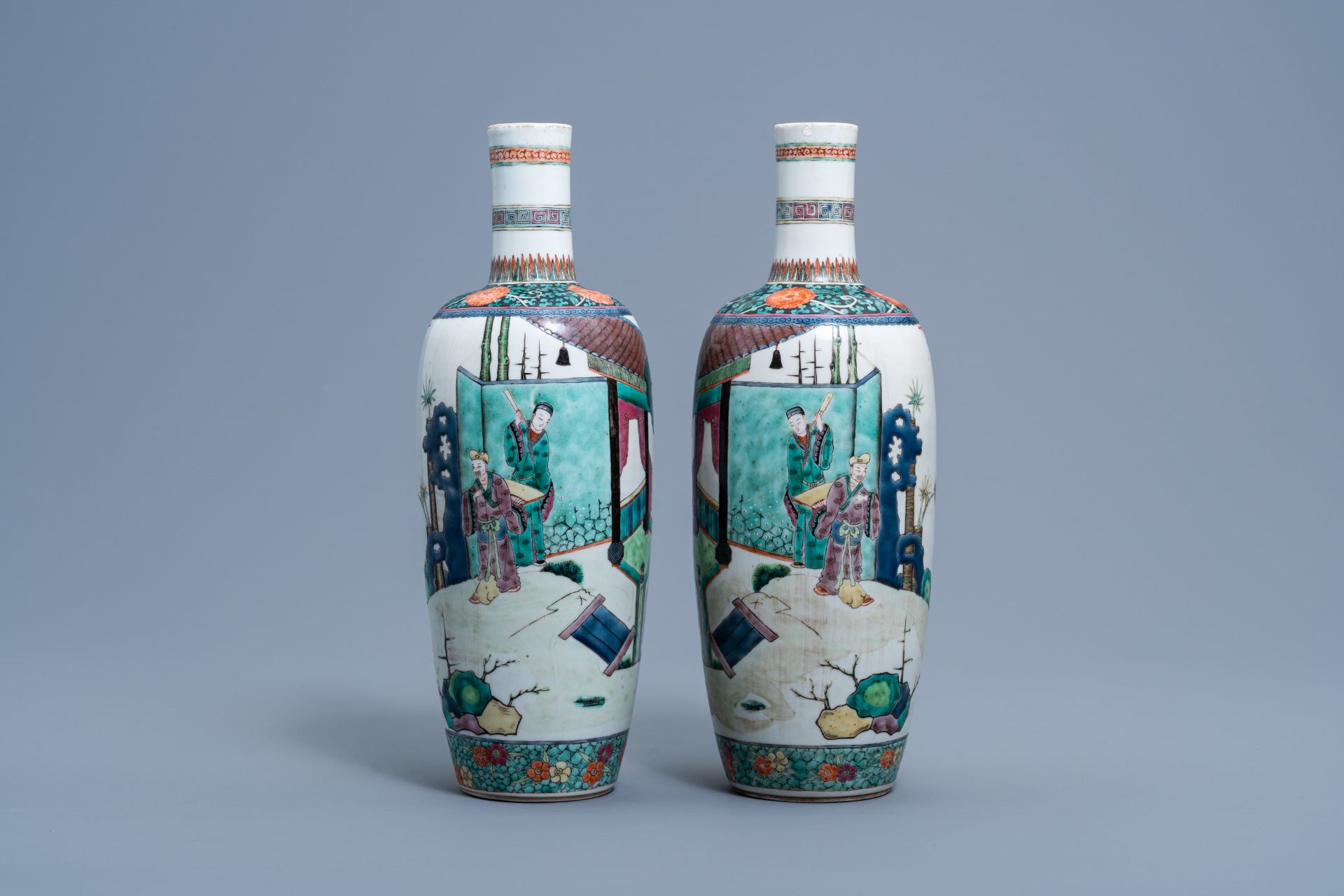 A pair of Chinese bottle shaped famille verte vases with figures in a landscape, 19th C.
