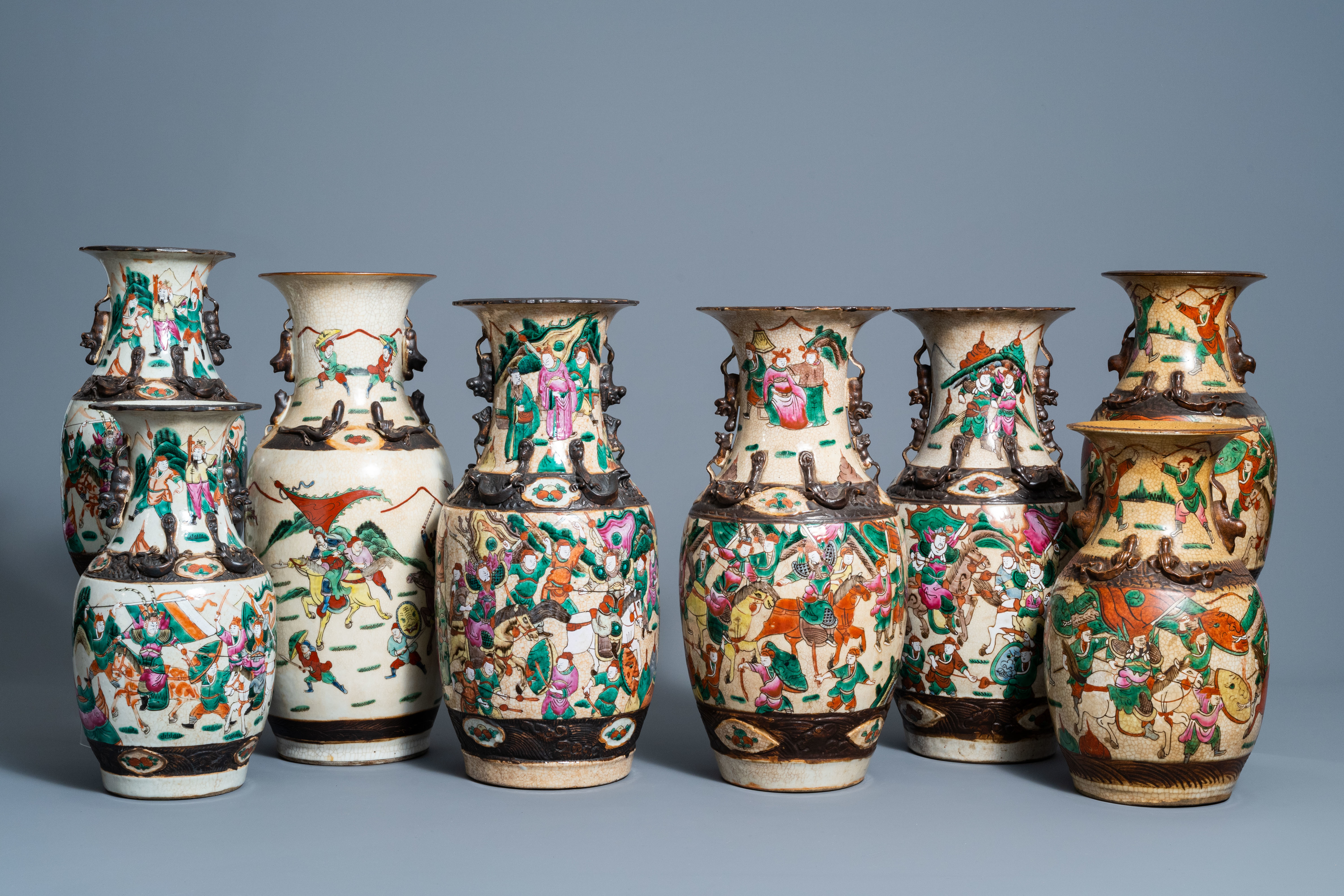 A varied collection of eight Chinese Nanking crackle glazed famille rose and verte vases with warrio