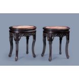 A pair of oval Chinese carved wood stands with marble top, 19th/20th C.