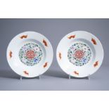 A pair of Chinese famille rose 'bats and Shou' dishes with lime green ground backs, Qianlong mark, 2