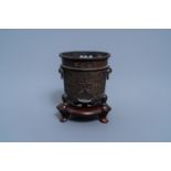 A Chinese bronze brush pot on wooden stand, Qing