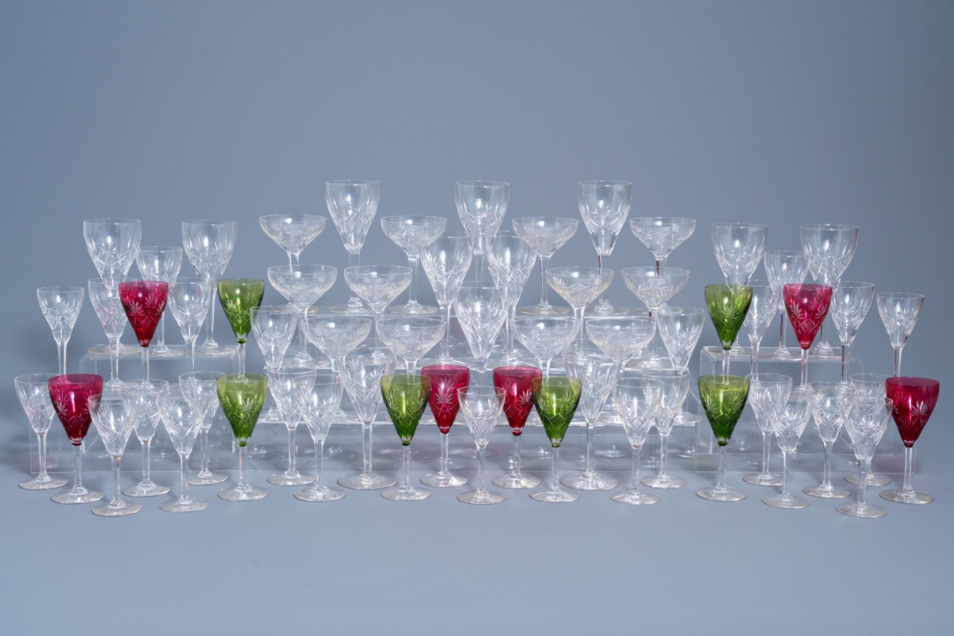 An extensive collection of clear and partly coloured overlay crystal cut glasses, 20th C.