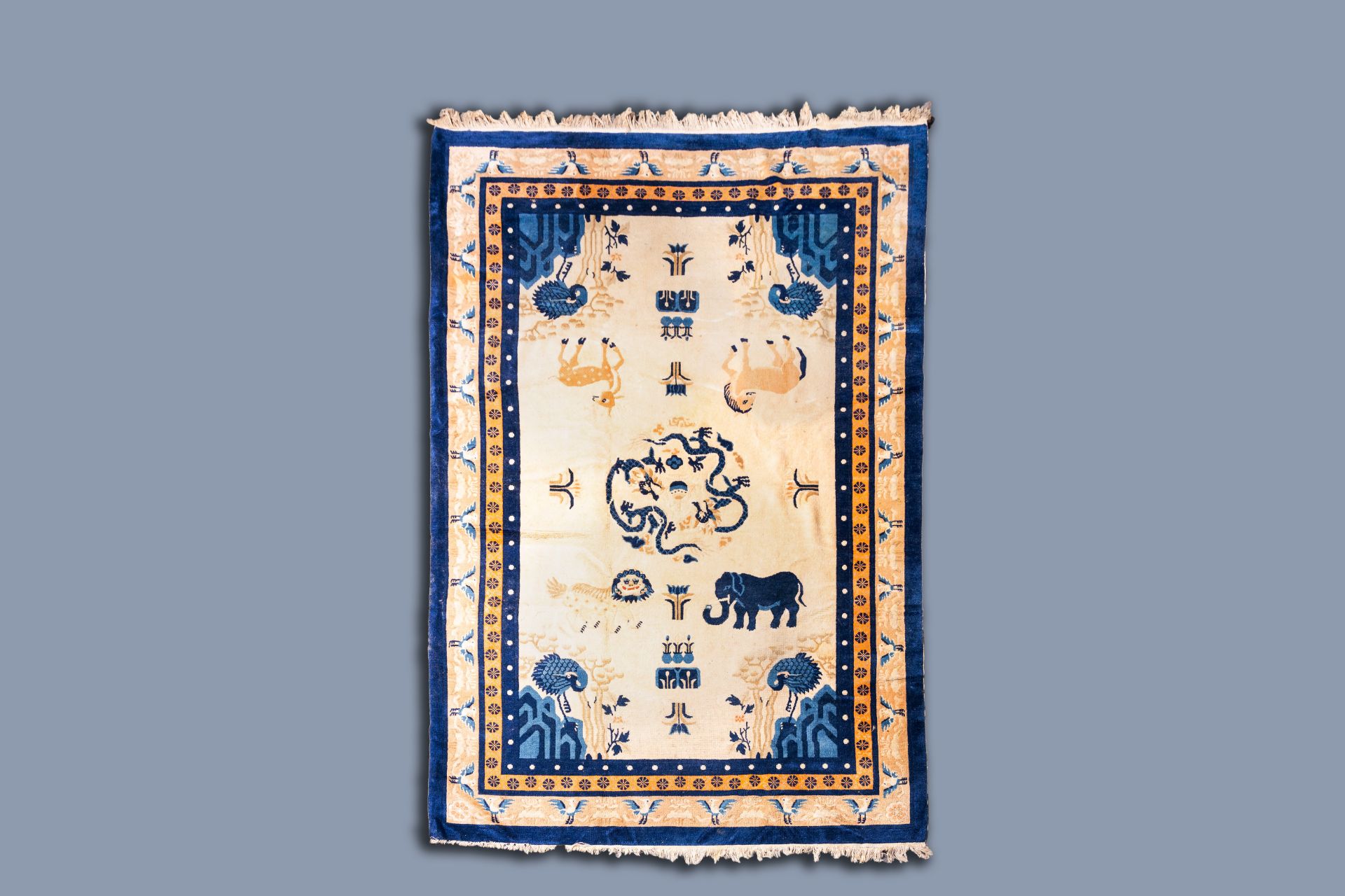 A Chinese woolen 'Beijing' pictorial animal rug with a blue elephant, first quarter of the 20th C.