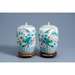 A pair of Chinese famille rose jars and covers with birds among blossoming branches, 19th C.