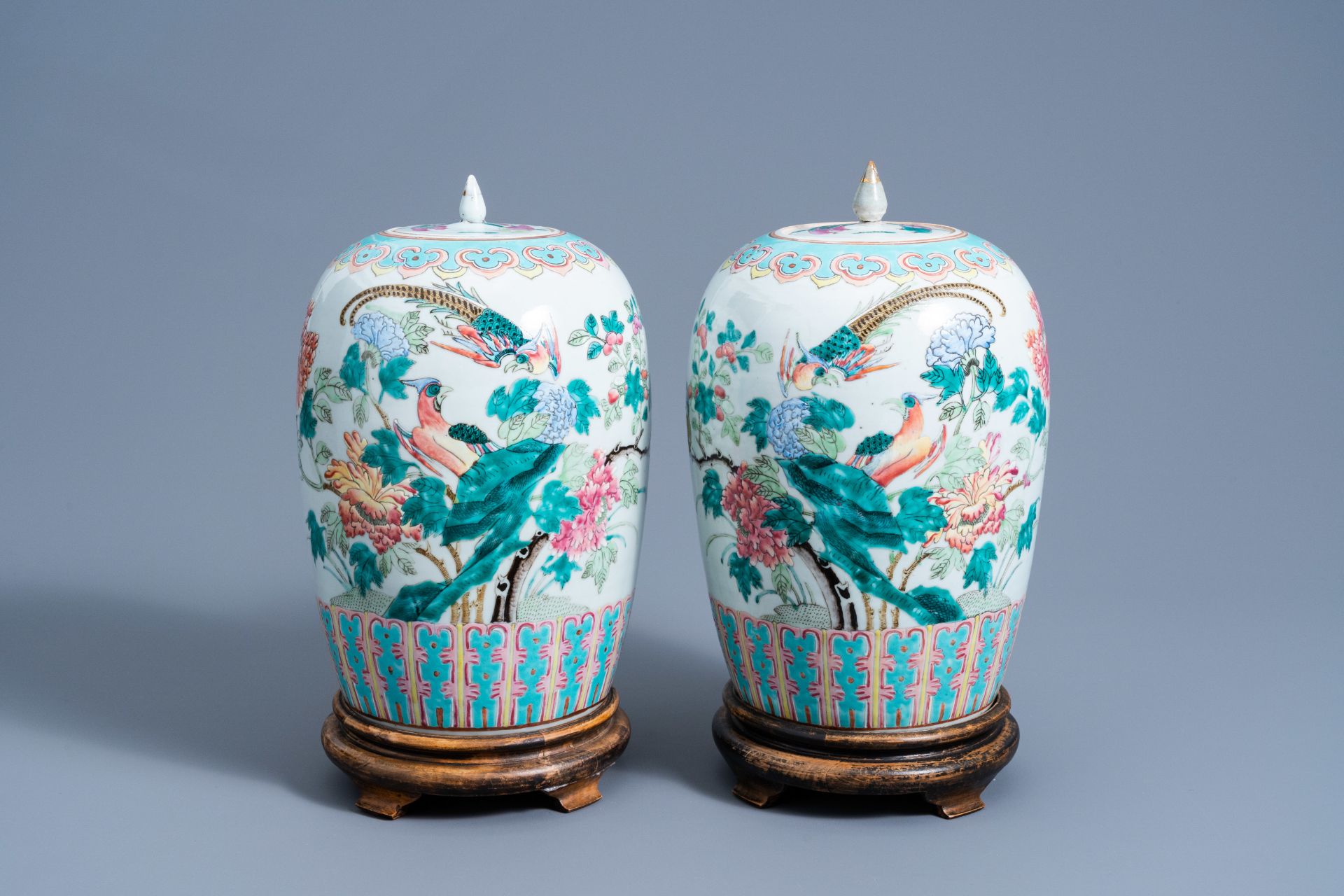 A pair of Chinese famille rose jars and covers with birds among blossoming branches, 19th C.