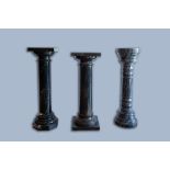 Three grey and black marble pedestals, 20th C.