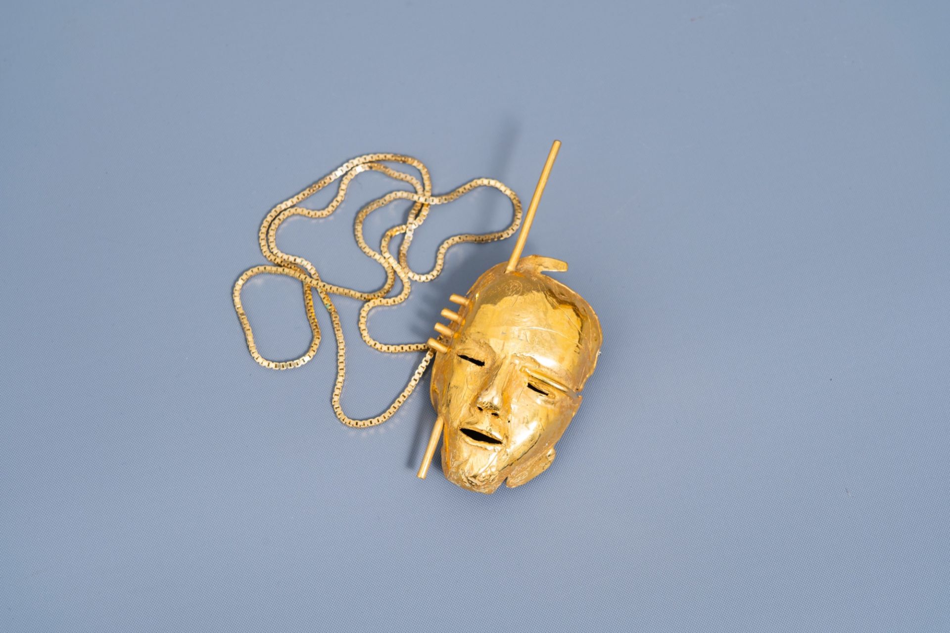 Bernard Vandenberghe (20th C.): A necklace with a gilt mask pendant