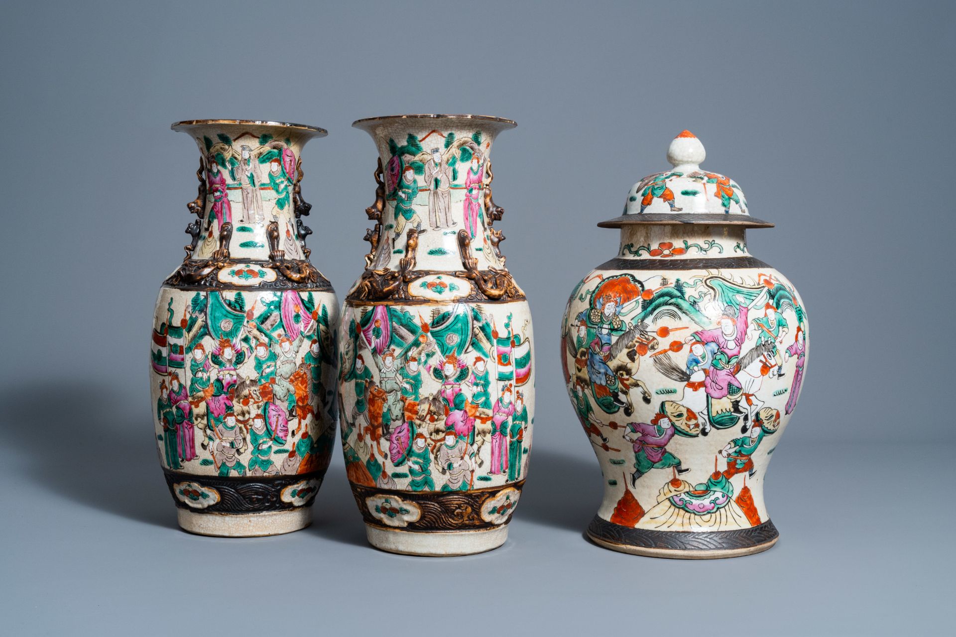 A pair of Chinese Nanking crackle glazed famille rose vases and a vase and cover with warrior scenes