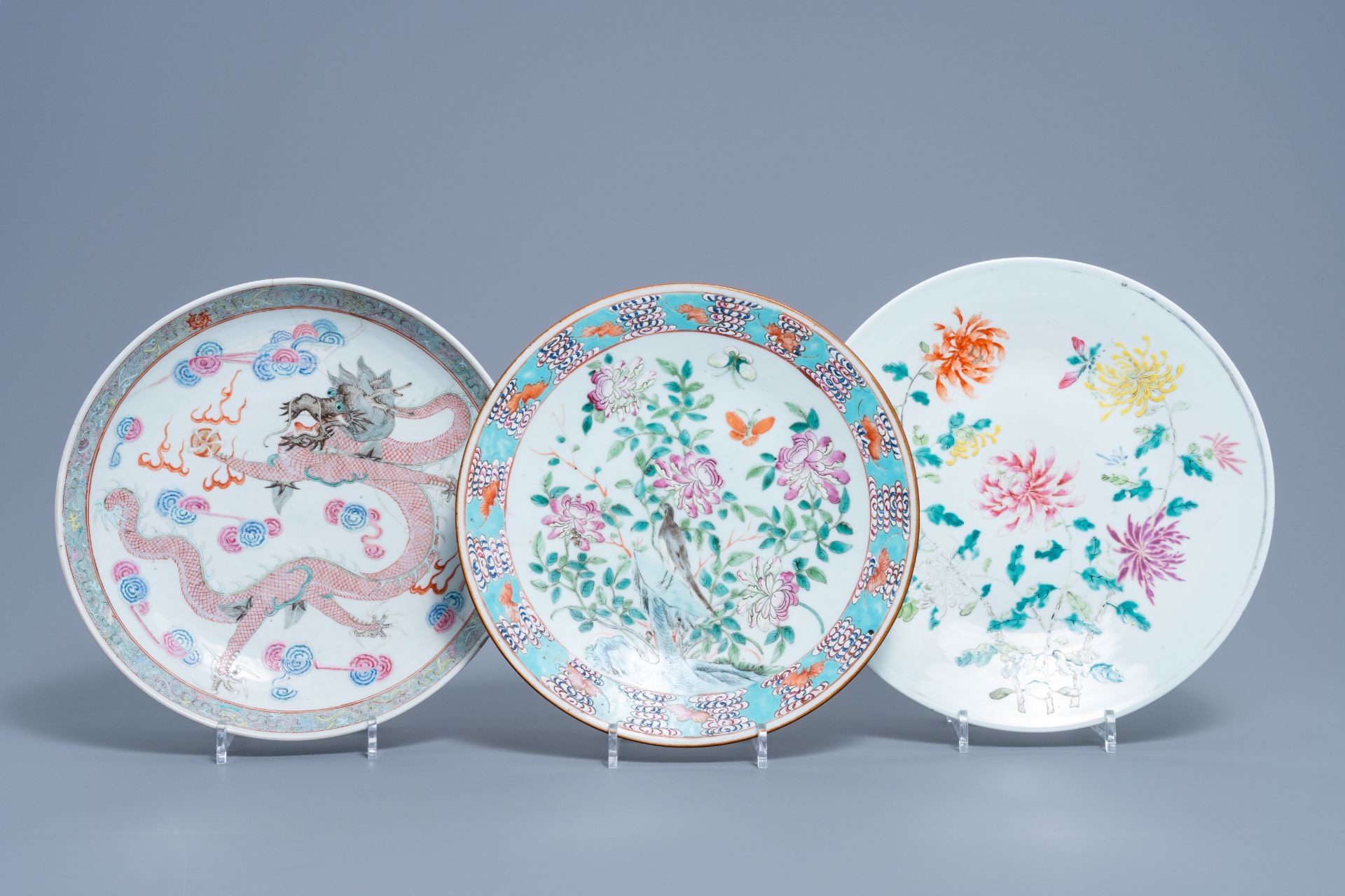 Three Chinese famille rose chargers with floral design and a dragon, 19th/20th C.