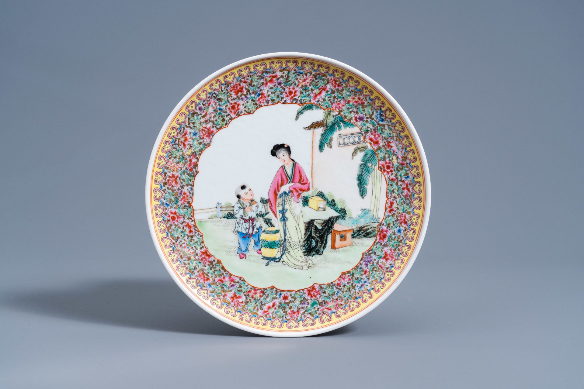 Two Chinese famille rose vases and covers and a plate with figures in a garden, Republic, 20th C. - Image 2 of 9