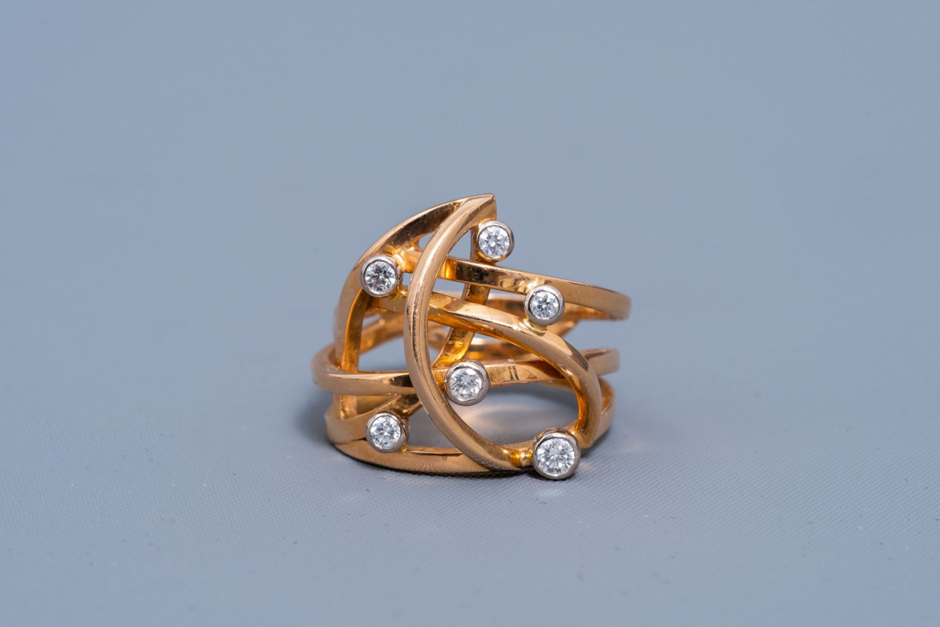 An 18 carat yellow and white gold ring set with six diamonds, 20th C.