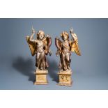 A pair of Italian carved, polychrome painted and gilt wooden angel shaped candlesticks, 18th C.