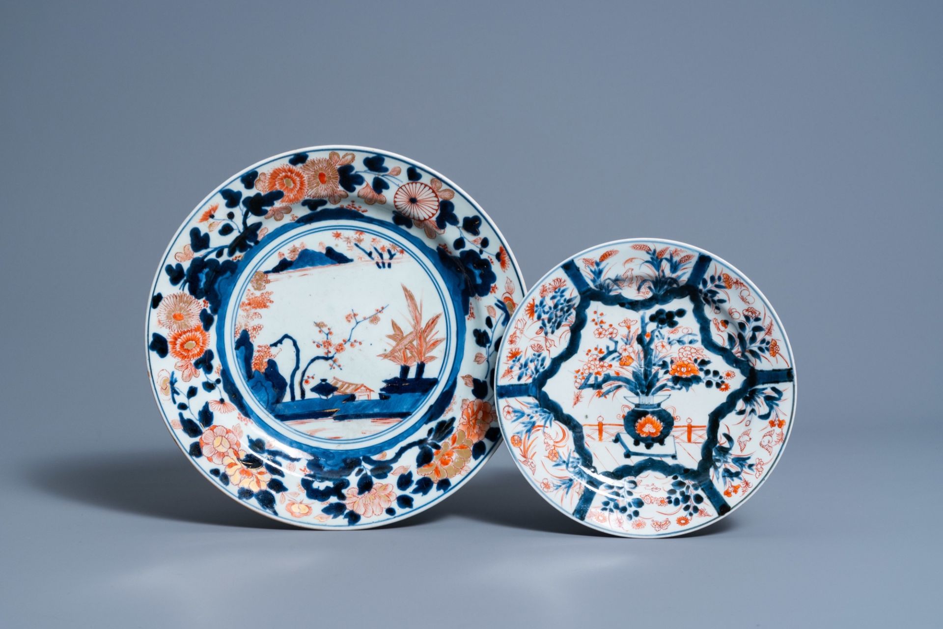 A Japanese Imari charger with a landscape and a plate with floral design, Edo, 18th C.