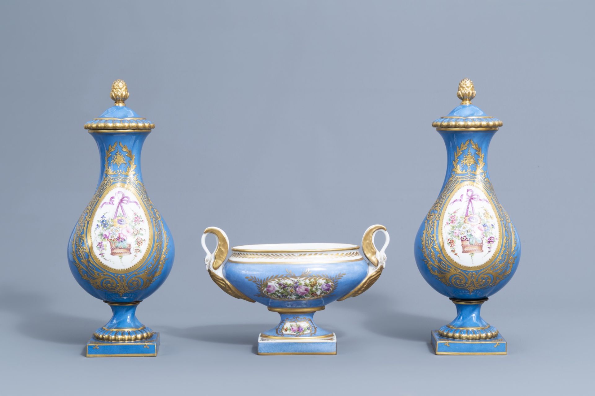 A pair of French gold layered 'bleu celeste' ground vases and covers in the Svres manner and an Emp