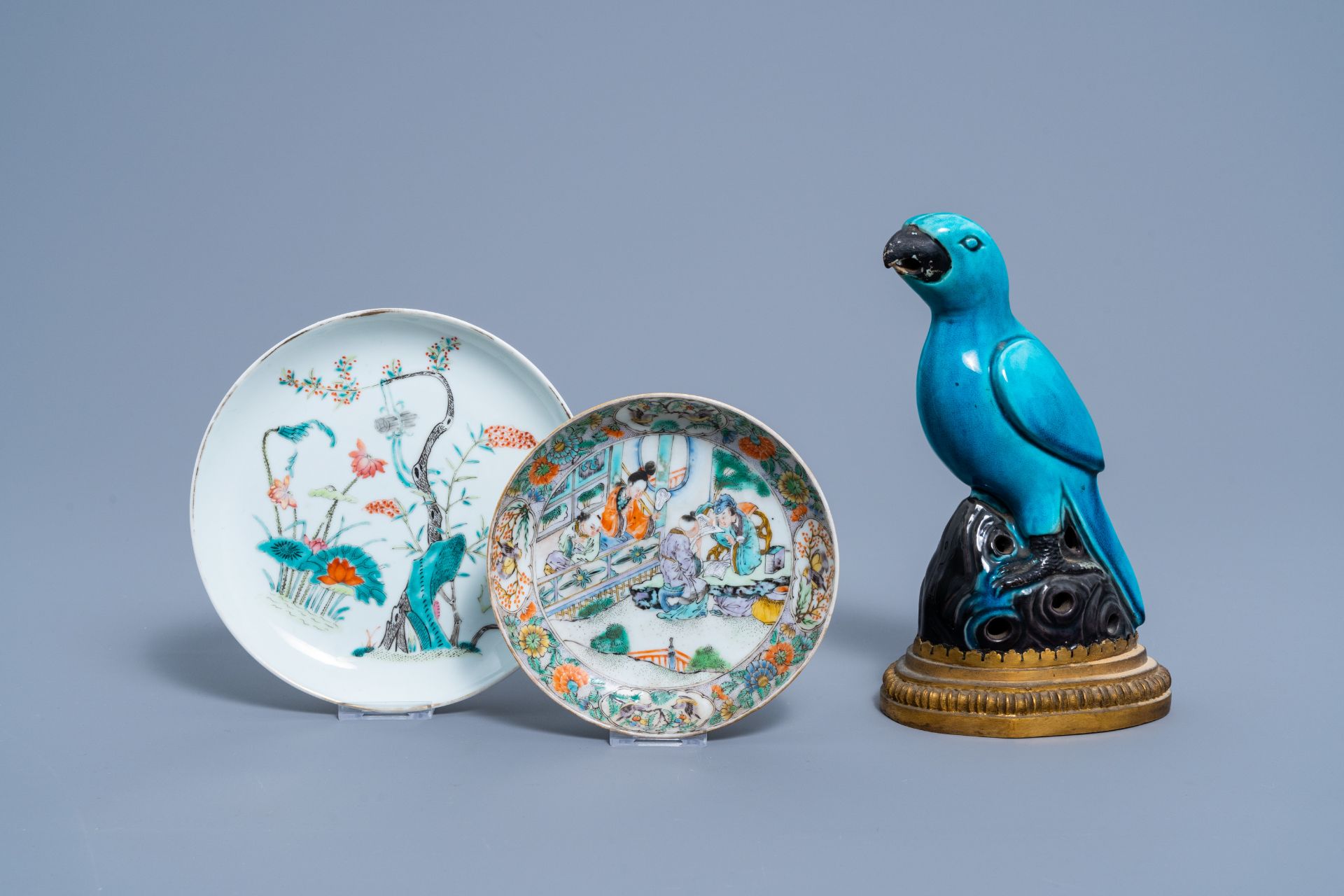 Two Chinese famille rose and verte plates and a turquoise and aubergine glazed parrot, 19th C.