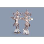 A pair of imposing Italian carved, polychrome painted and silver-plated wood angel shaped candlestic