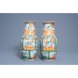A pair of Chinese Canton famille rose vases with palace scenes and birds among blossoming branches,