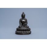 A Chinese bronze figure of Buddha on a lotus throne, 17th/18th C.