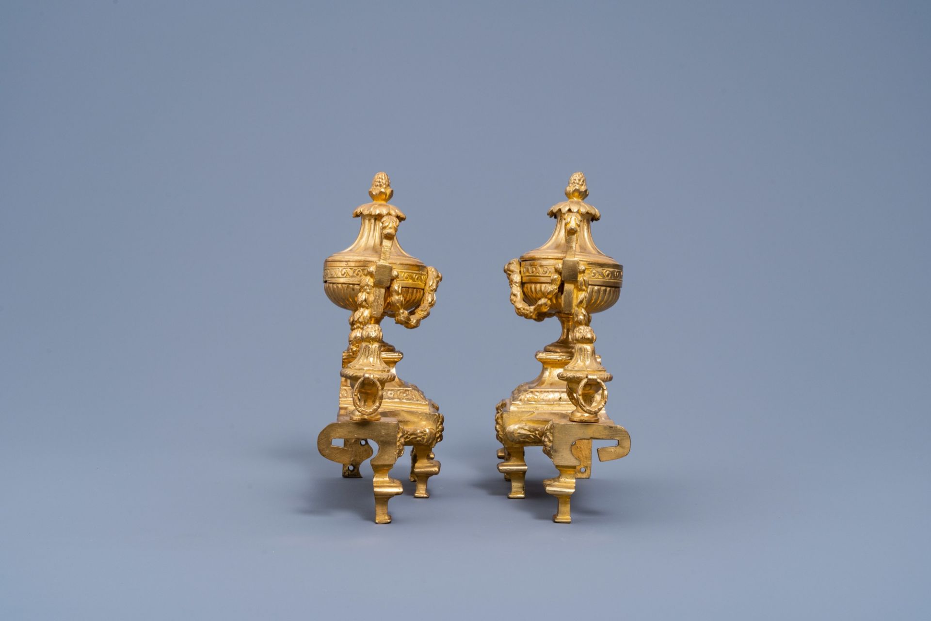 A pair of French Louis XVI style gilt bronze chenets and fire fender, 19th/20th C. - Image 6 of 11