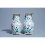 A pair of Chinese famille rose vases with birds among blossoming branches, 19th C.