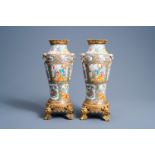 A pair of Chinese Canton famille rose brass mounted baluster vases, 19th C.