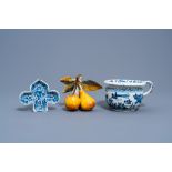 A Dutch Delft blue and white chamber pot, a dish and a polychrome apple and pear fruit group, 18th C